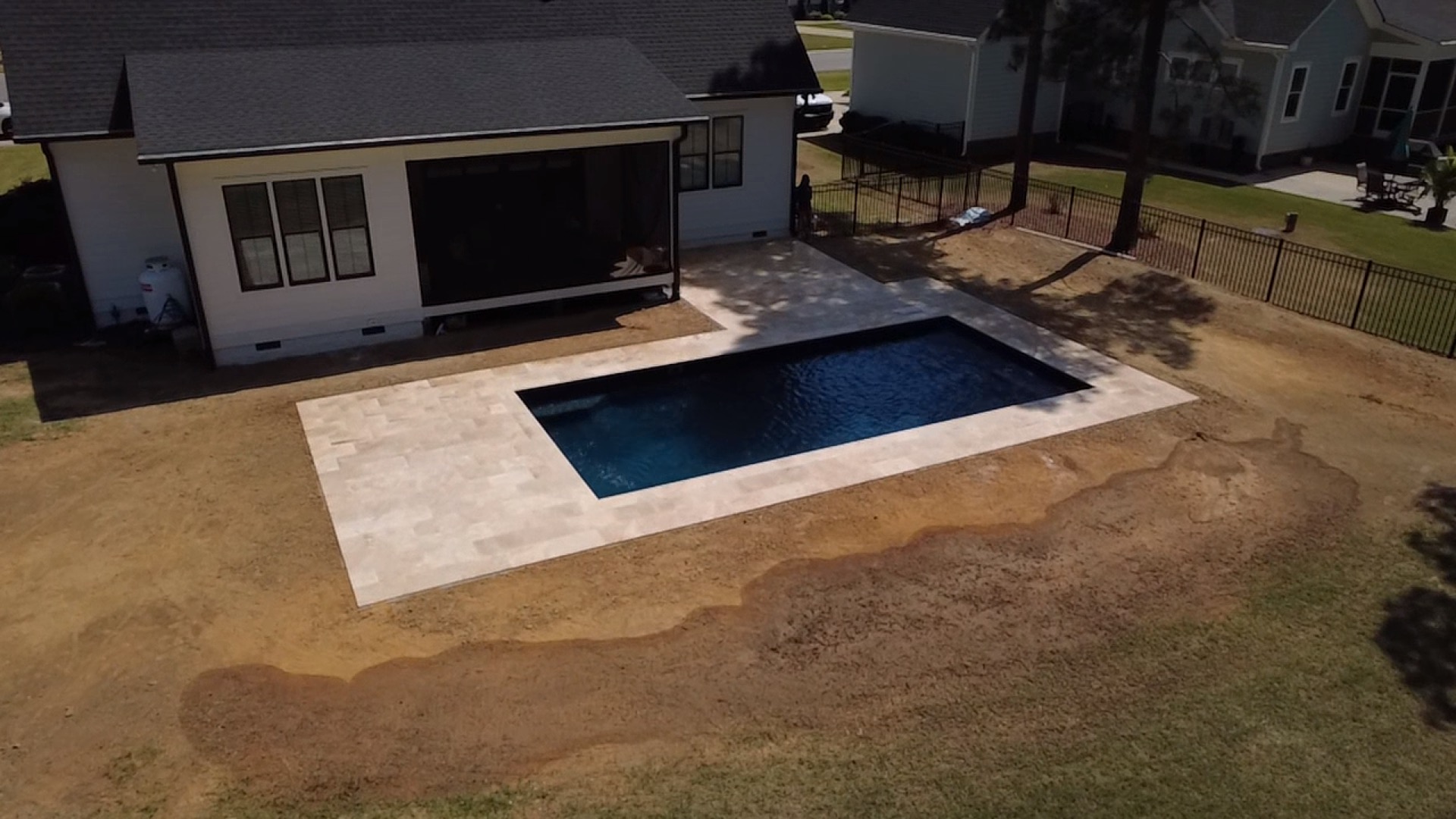 Aerial drone shot of travertine pool deck