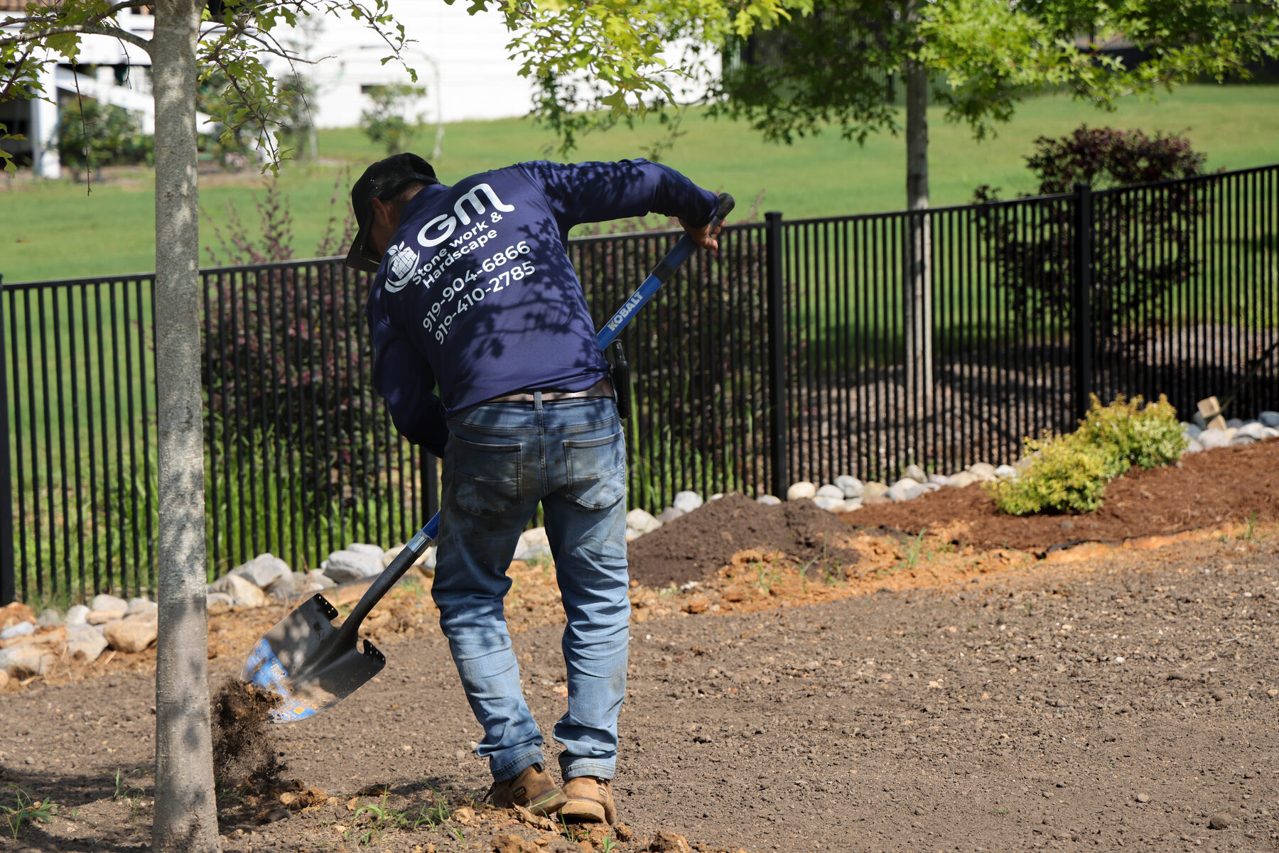 Cutting in a new bed line along the fence