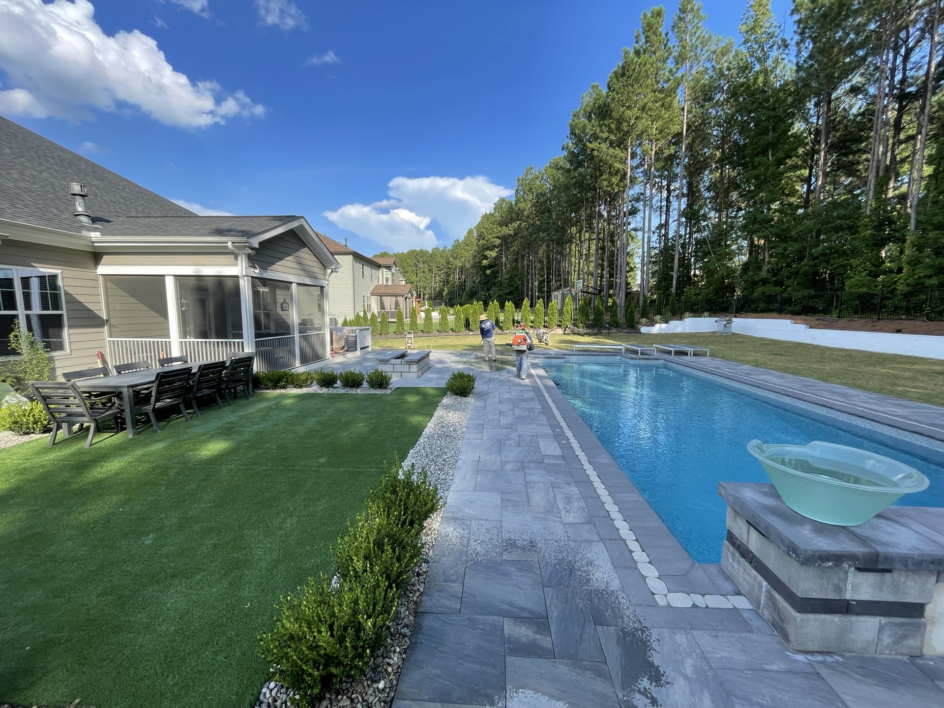Pool with paver patio and water feature