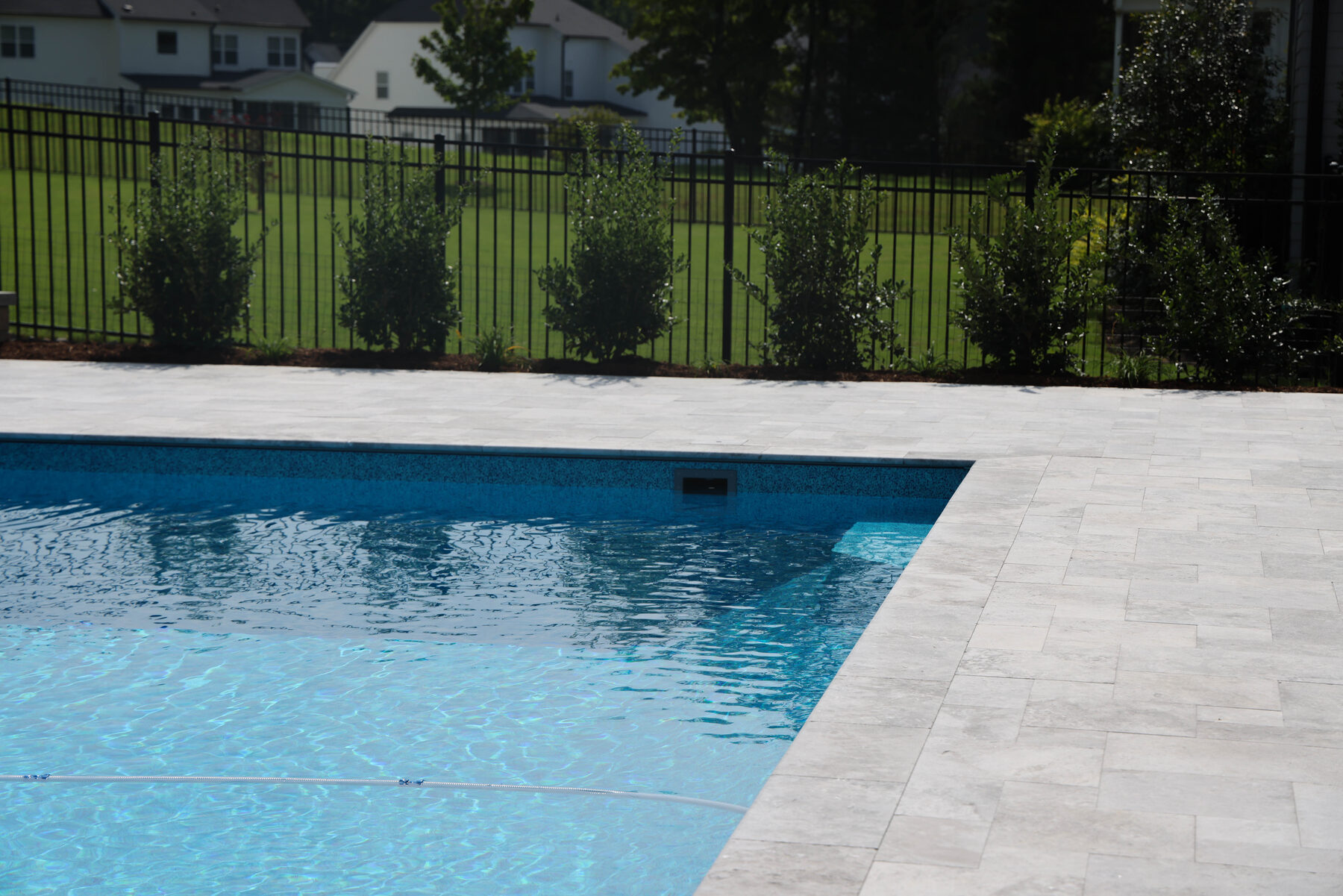 Pool deck with light stone coping