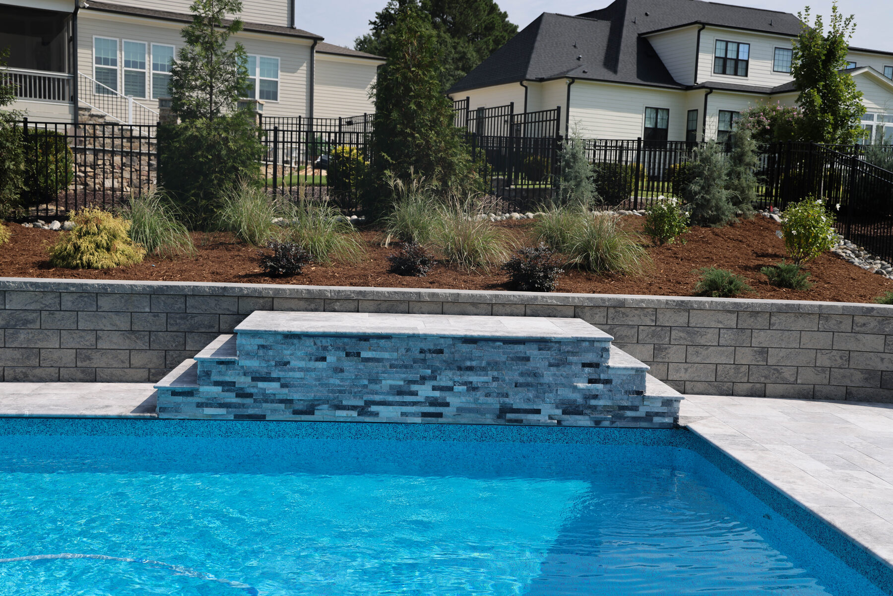 Pool with raised wall and water feature
