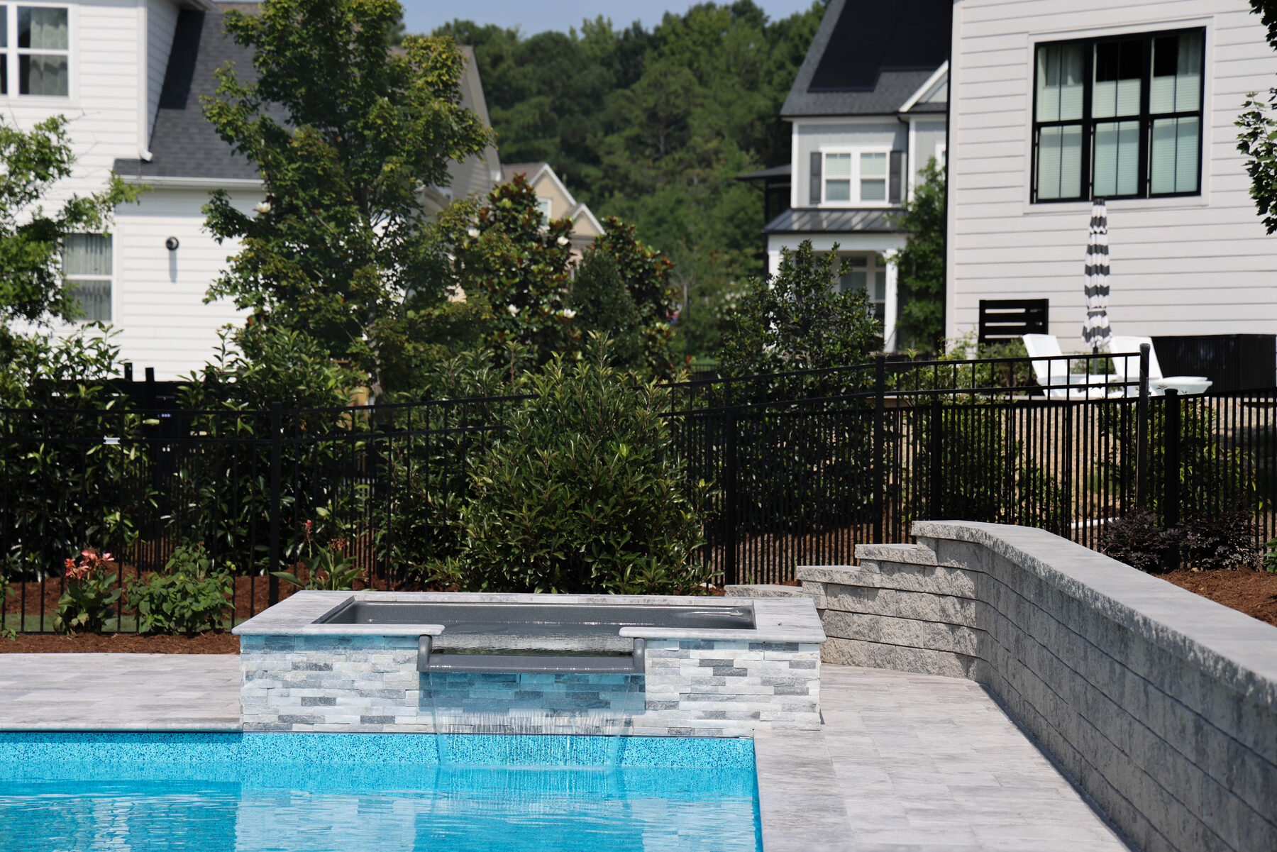 Pool and spa with spillover